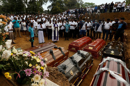 FILE PHOTO: People participate in a mass funeral, of the seven victims belonging to one family, in Negombo, three days after a string of suicide bomb attacks on churches and luxury hotels across the island on Easter Sunday, in Sri Lanka April 24, 2019. REUTERS/Thomas Peter/File Photo