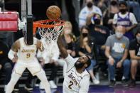 Los Angeles Lakers center Andre Drummond scores against the Phoenix Suns during the first half of Game 1 of their NBA basketball first-round playoff series Sunday, May 23, 2021, in Phoenix. (AP Photo/Ross D. Franklin)