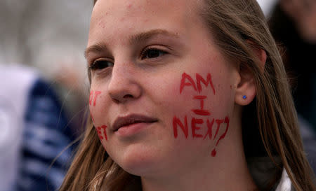 Delaney Peterson looks on as teens kick off a voter registration rally, a day ahead of the 19th anniversary of the massacre at Columbine High School, in Littleton, Colorado, U.S., April 19, 2018. REUTERS/Rick Wilking