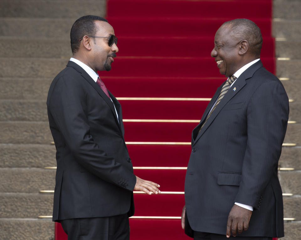 South African President Cyril Ramaphosa, right, welcomes Ethiopia's Prime Minister Abiy Ahmed prior to their talks at the Union Building in Pretoria, South Africa, Sunday, Jan. 12, 2020. (AP Photo/Themba Hadebe)