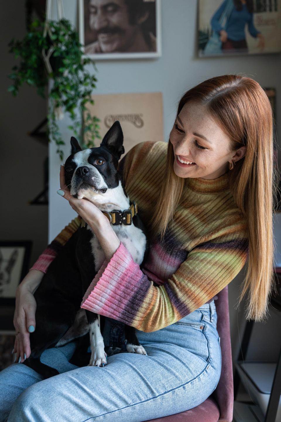 Liz Fleming, known as Liz from Iowa on TikTok, and her dog Chandler, pose for a photo at her home in Des Moines.