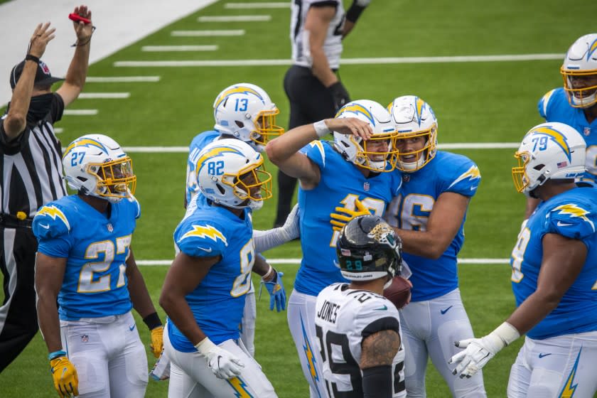 INGLEWOOD, CA - OCTOBER 25: Jaguars' safety Josh Jones, bottom center, watches Chargers quarterback Justin Herbert.