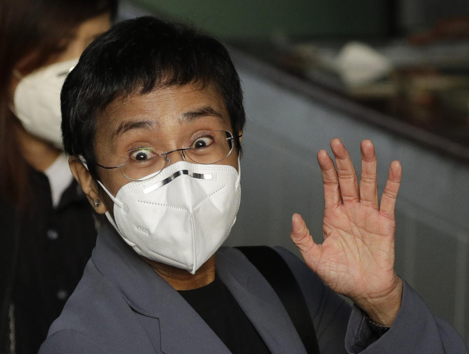 <p>Rappler CEO and Executive Editor Maria Ressa, wearing a protective mask, waves to the media before attending a court hearing at Manila Regional Trial Court, Philippines on Monday June 15, 2020. Ressa’s verdict is expected to be announced Monday for a cyber libel case. (AP Photo/Aaron Favila)</p>
