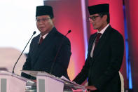 Indonesian presidential candidate Prabowo Subianto delivers his speech, with running mate Sandiaga Uno, right, during a televised debate in Jakarta, Indonesia, Thursday, Jan. 17, 2019. Indonesia is gearing up to hold its presidential election on April 17 that will pit in the incumbent against the former general.(AP Photo / Tatan Syuflana)