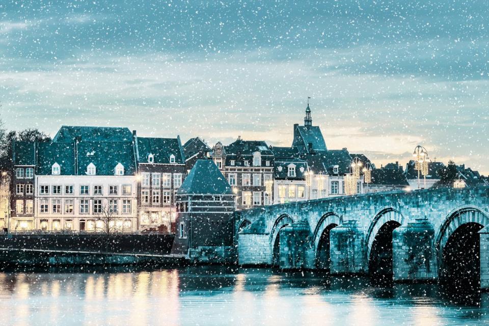 winter view of the famous dutch sint servaas bridge with lights in the city center of maastricht