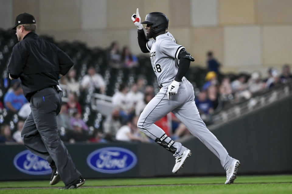 Chicago White Sox's Luis Robert celebrates as he rounds the bases after hitting a home run against the Minnesota Twins during the ninth inning of a baseball game, Tuesday, April 11, 2023, in Minneapolis. Twins won 4-3. (AP Photo/Craig Lassig)