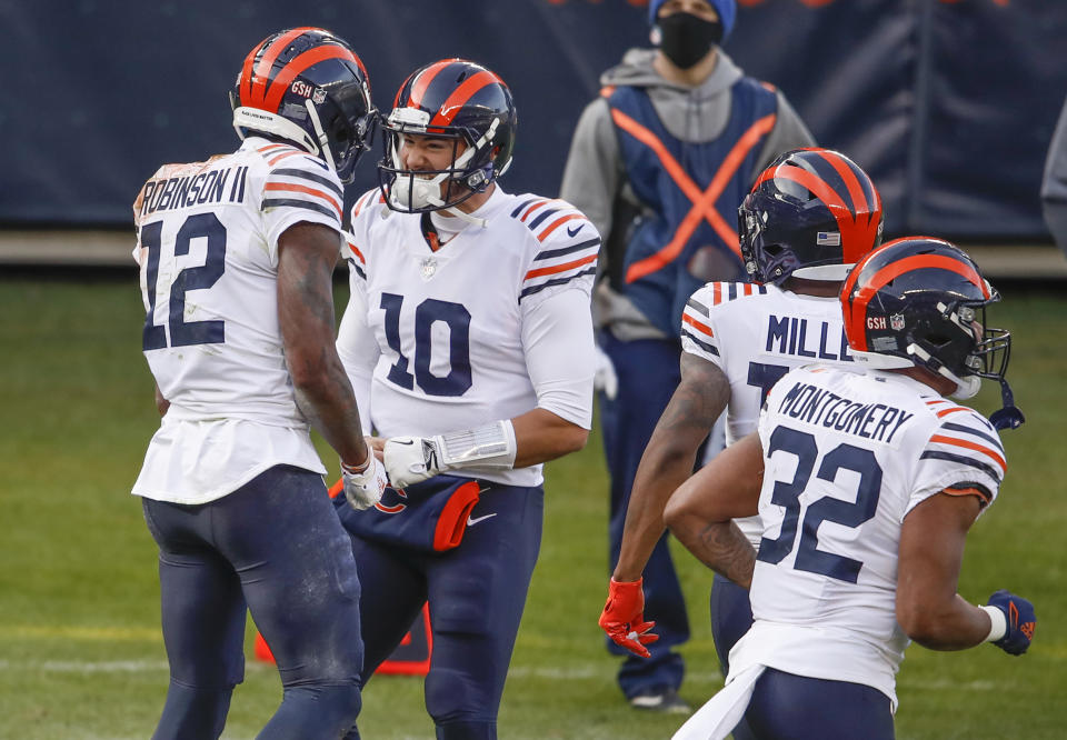 FILE - In this Dec. 13, 2020, file photo, Chicago Bears wide receiver Allen Robinson (12) celebrates with quarterback Mitchell Trubisky (10) after scoring a touchdown against the Houston Texans during the first half of an NFL football game in Chicago. General manager Ryan Pace had few answers when it came to the two biggest questions facing the Bears in the offseason. He wouldn't rule out anything when it comes to a potential starting quarterback next year, not even a return for Trubisky. And he said the Bears haven't decided whether to use the franchise tag on star receiver Robinson. (AP Photo/Kamil Krzaczynski, File)