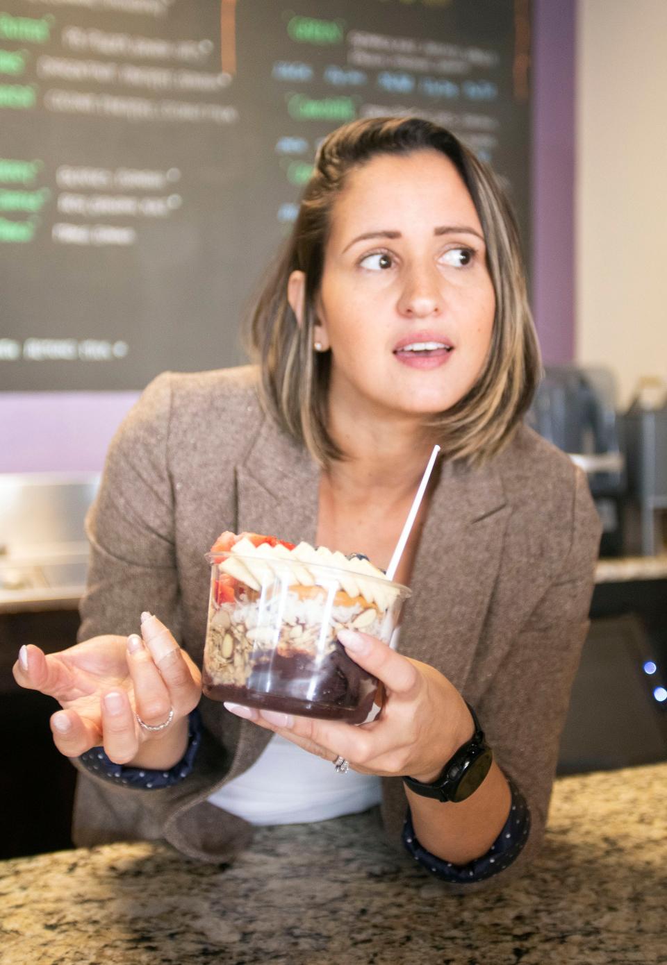 Acai Bowls Tropical Fusion owner Wilmary Amaya describes the benefits of her Acai bowls while opening her Gulf Breeze store on Wednesday, Jan. 18, 2023. Amaya will open a second location at the Garden in downtown Pensacola within the next few days.