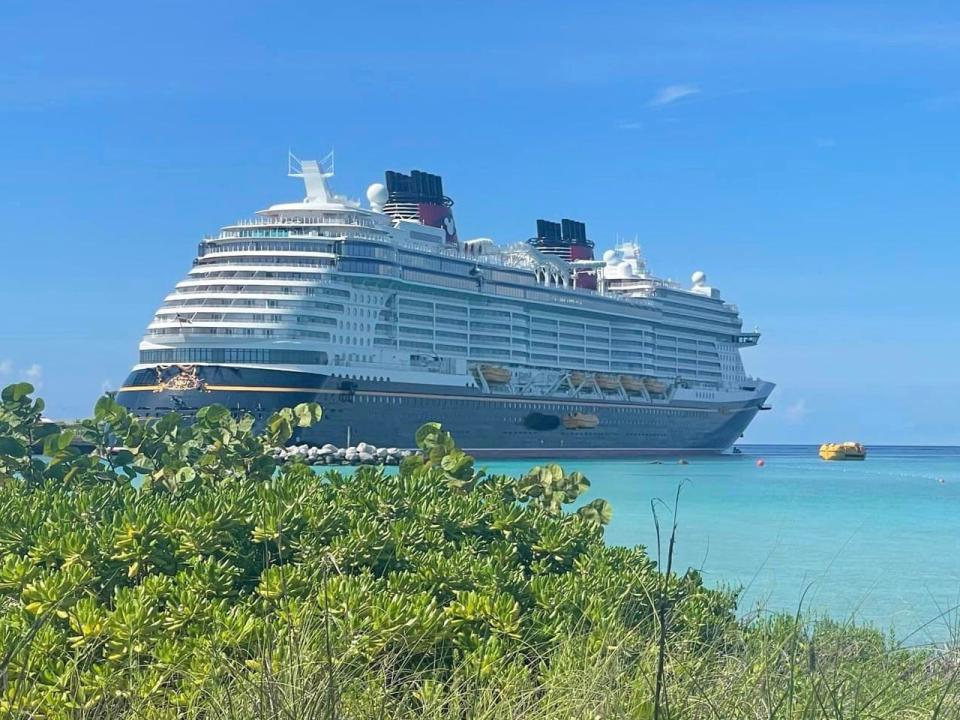 A Disney Wonder cruise ship docked at Disney's private island, Castaway Cay.
