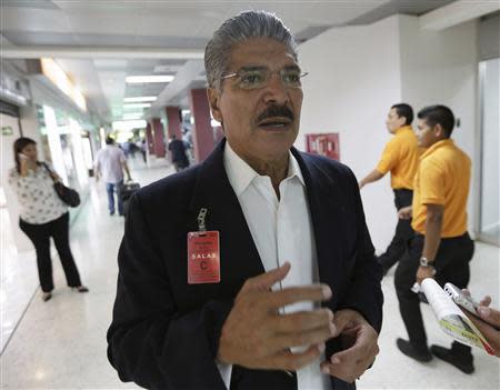 Norman Quijano, presidential candidate of the conservative Nationalist Republican Alliance party (ARENA) speaks to Reuters journalists about his demand for the annulment of the election, at the international airport in San Salvador March 11, 2014. REUTERS/Henry Romero