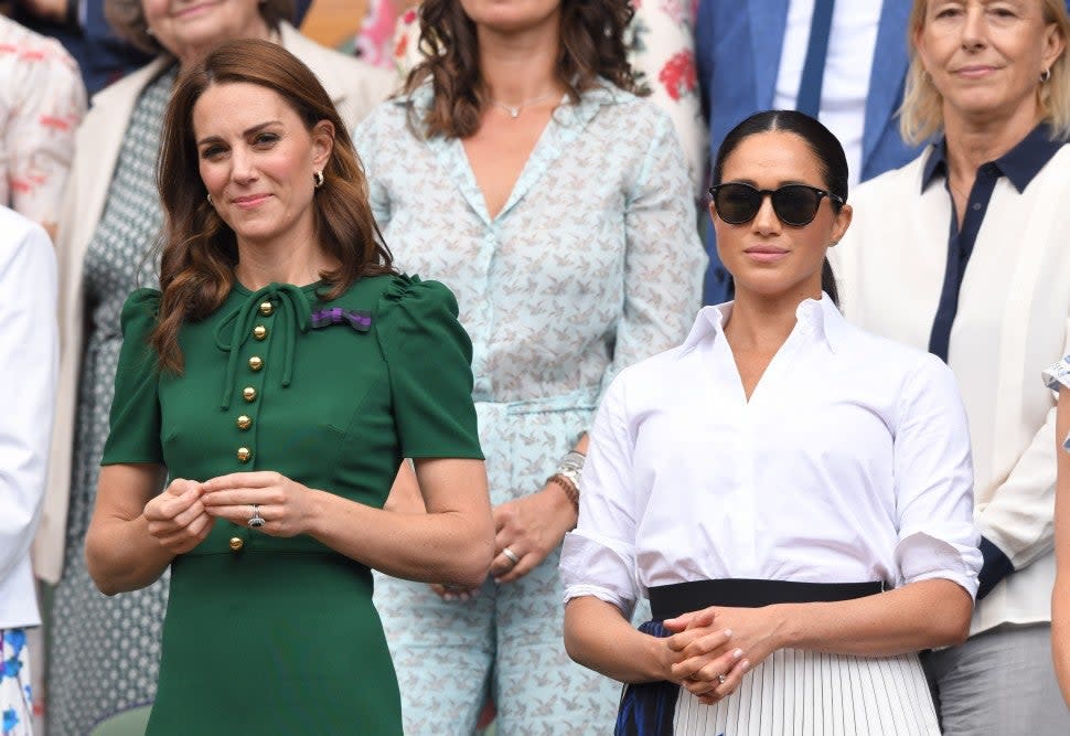 Catherine, Duchess of Cambridge and Meghan, Duchess of Sussex in the Royal Box on Centre Court during day twelve of the Wimbledon Tennis Championships at All England Lawn Tennis and Croquet Club on July 13, 2019 in London, England. 