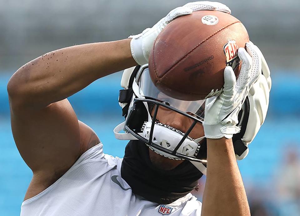 Carolina Panthers running back Chuba Hubbard keeps his eyes on the ball as he catches passes prior to the team’s Fan Fest practice at Bank of America Stadium on Wednesday, August 2, 2023.