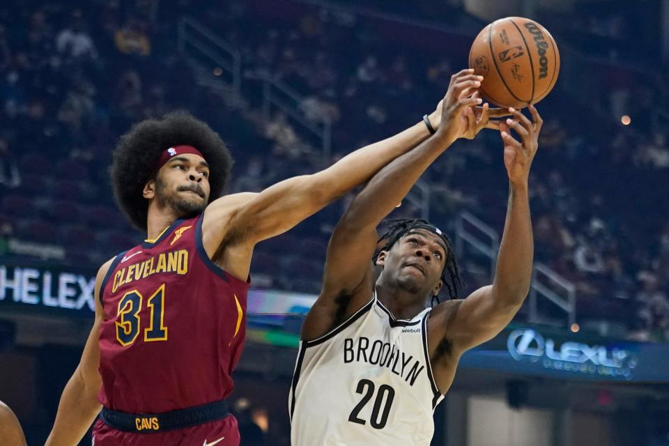 Cleveland Cavaliers' Jarrett Allen (31) and Brooklyn Nets' Day'Ron Sharpe (20) battle for a rebound in the first half of an NBA basketball game, Monday, Jan. 17, 2022, in Cleveland. (AP Photo/Tony Dejak)