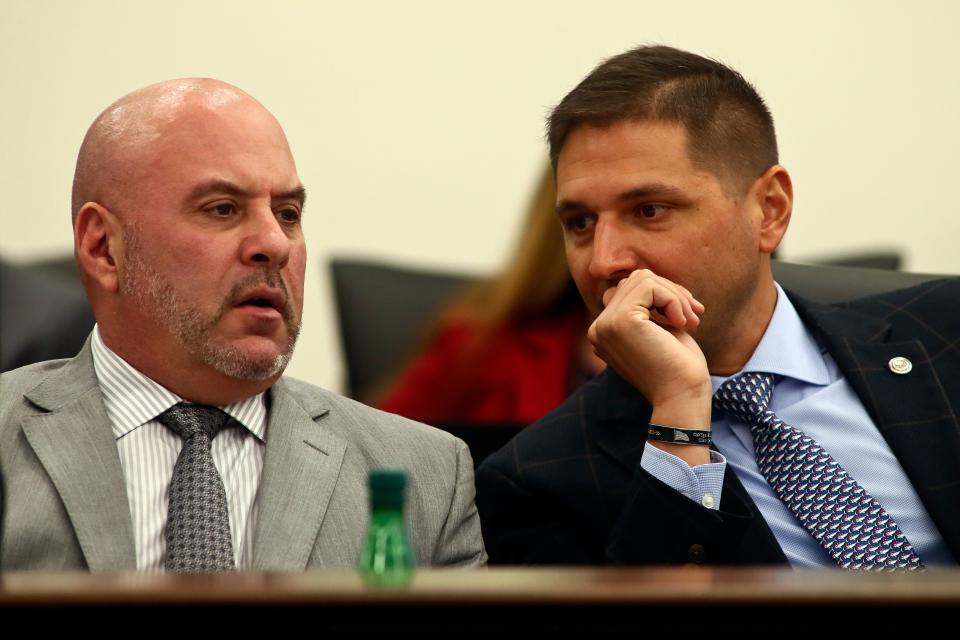 Sen. Blaise Ingoglia, R-Spring Hill, left, and Sen. Danny Burgess, R-Zephyrhills, confer during the Committee on Banking and Insurance meeting Monday, Dec. 12, 2022, at the Capitol in Tallahassee, Fla. Florida lawmakers are meeting to consider ways to shore up the state's struggling home insurance market in the year's second special session devoted to the topic. (AP Photo/Phil Sears)