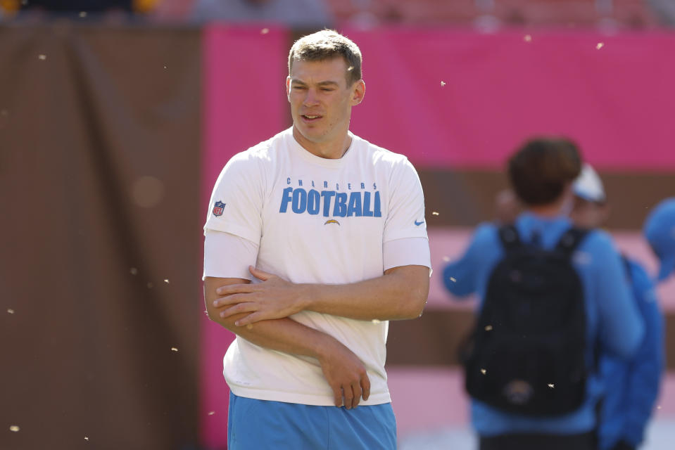 Los Angeles Chargers quarterback Easton Stick brushes flying insects away as he warms up before an NFL football game against the Cleveland Browns, Sunday, Oct. 9, 2022, in Cleveland. (AP Photo/Ron Schwane)