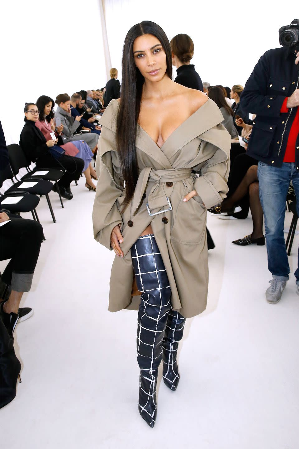 <p>In a Balenciaga trench and over-the-knee boots during Paris Fashion Week. </p>