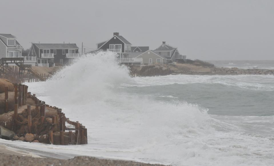 Storm driven waves crash up against the large woven sandbags and mounds of sand protecting the homes along Bay Beach Lane on Town Neck Beach about an hour after Sunday morning's high tide. To see more photos, go to www.capecodtimes.com. Merrily Cassidy/Cape Cod Times