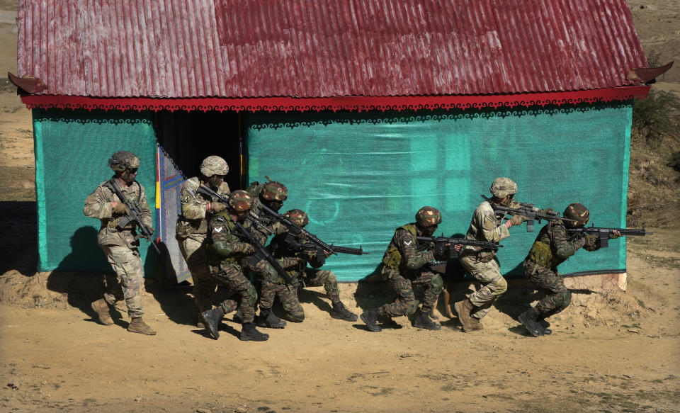 US army soldiers of 2nd Brigade of the 11th Airborne Division with Indian army soldiers carry out a mock operation to flush out armed gunmen from a house during the Indo-US joint exercise or "Yudh Abhyas, in Auli, in the Indian state of Uttarakhand, Tuesday, Nov. 29, 2022. Militaries from India and the U.S. are taking part in a high-altitude training exercise in a cold, mountainous terrain close to India's disputed border with China. The training exercise began two weeks ago. India's defence ministry statement said the joint exercise is conducted annually with the aim of exchanging best practices, tactics, techniques and procedures between the armies of the two nations, which is under Chapter of the UN Mandate. (AP Photo/Manish Swarup)