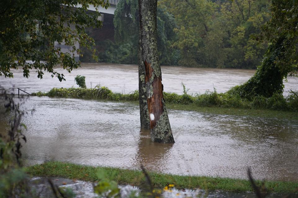 The French Broad River rises above its banks in the River Arts District on Friday, September 26. Hurricane Helene is bringing heavy rains to Asheville.