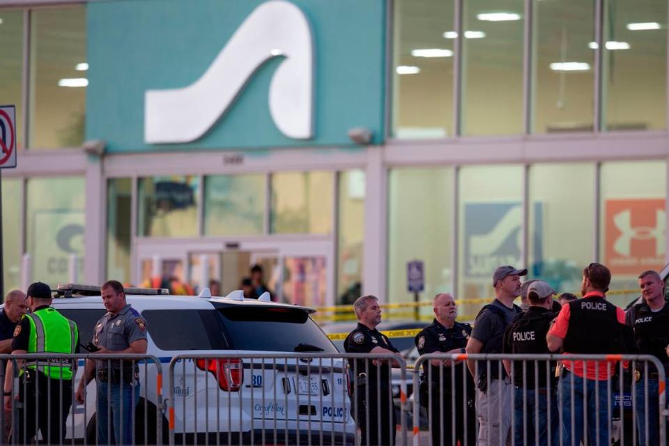 Law enforcement officers stand outside Surf Style in Biloxi after a chaotic shooting during Black Spring Break that left one police officer injured on Sunday, April 16, 2023.