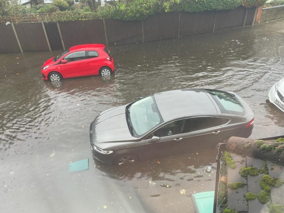 Cars are parked along roads submerged in floodwater along the streets of London (Independent TV)