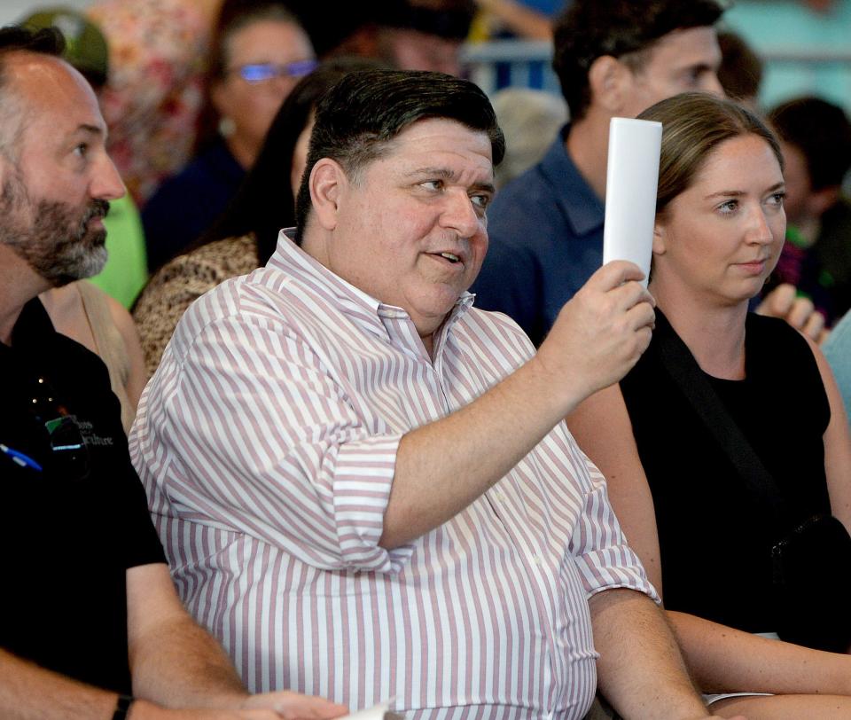 Gov. JB Pritzker bids on Grand Champion Steer King during the Governor's Sale of Champions at the Illinois State Fair on Tuesday, Aug. 16, 2022.