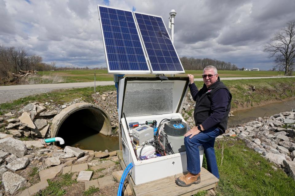 Duane Stateler shows off part of the edge-of-field testing system developed by the USDA that sits on part of his 900-acre farm in McComb, Ohio. The system measures nitrogen, phosphorus and potassium in water from surface run-off water as well as from drainage tile below the surface.