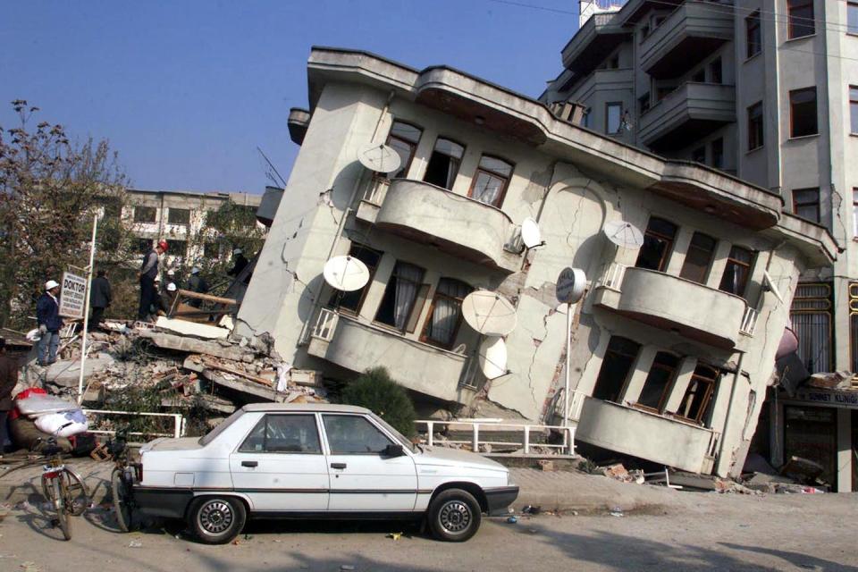 The destruction caused by Turkey’s 1999 earthquake. <a href="https://www.gettyimages.com/detail/news-photo/car-is-parked-in-front-of-a-destroyed-building-in-duzce-14-news-photo/51398243?phrase=earthquake%201999%20turkey&adppopup=true" rel="nofollow noopener" target="_blank" data-ylk="slk:Manoocher Deghati/AFP via Getty Image;elm:context_link;itc:0;sec:content-canvas" class="link ">Manoocher Deghati/AFP via Getty Image</a>