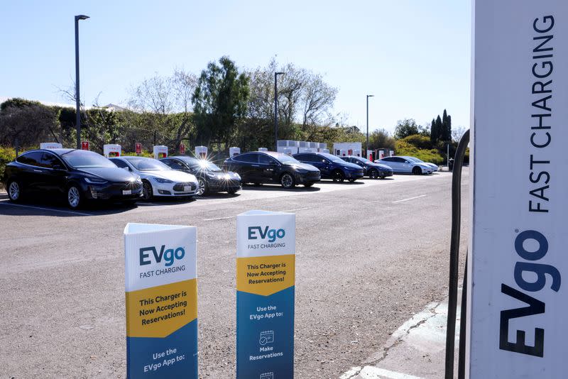 FILE PHOTO: Peopole charge electric cars in California