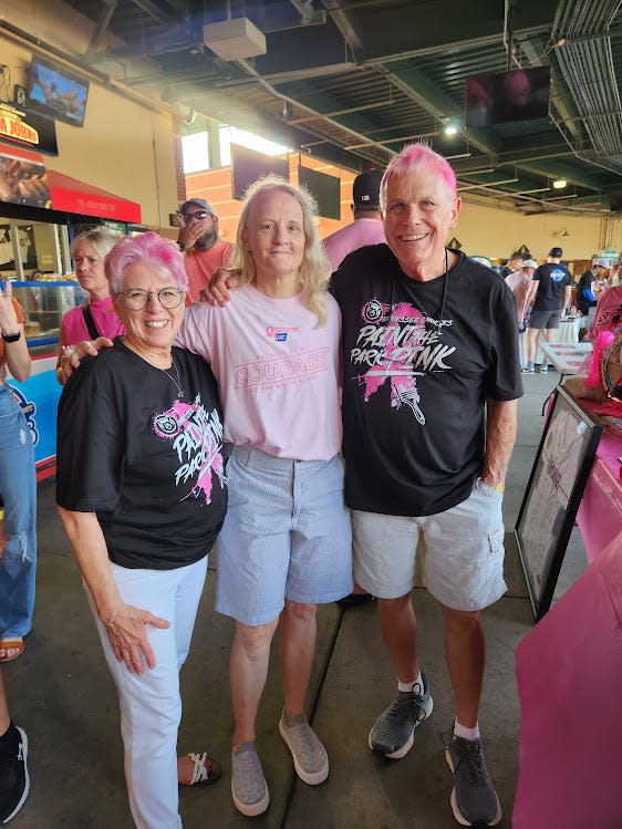 A panorama of pink Aug. 5 at Smokies Stadium: Breast cancer survivors Mary Ann Venable and Maria Cornelius, along with News Sentinel columnist Sam Venable — who used nearly half a bottle of shampoo after the game.