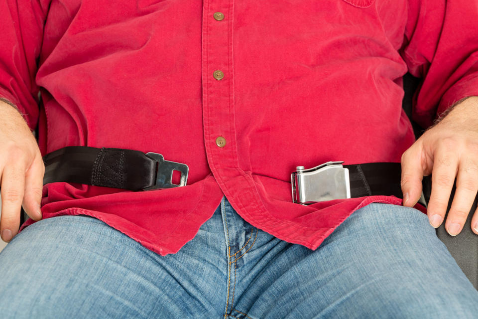 A debate has sparked online after a passenger charged an obese man for sitting in the seat next to him. Stock photo: Getty