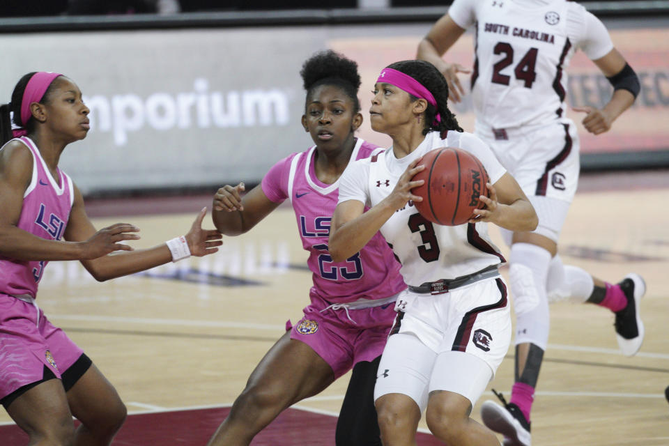 South Carolina guard Destanni Henderson (3) drives to the hoop against LSU guard Karli Seay (23) and Khayla Pointer (3) during the first half of an NCAA college basketball game Sunday, Feb. 14, 2021, in Columbia, S.C. (AP Photo/Sean Rayford)