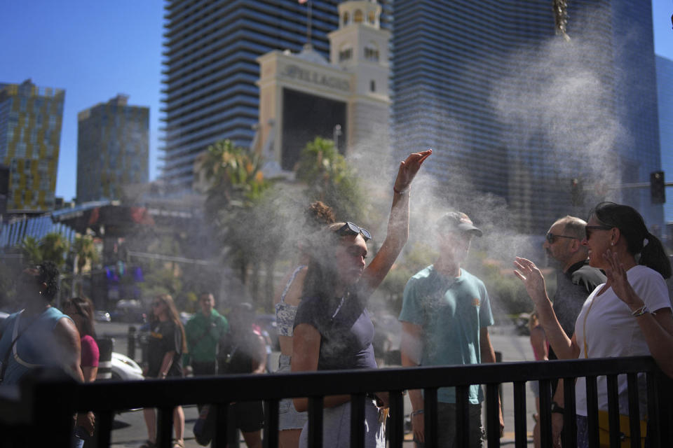 Cool people in mystery along the Las Vegas Strip on July 7th.  (John Locher/AP)