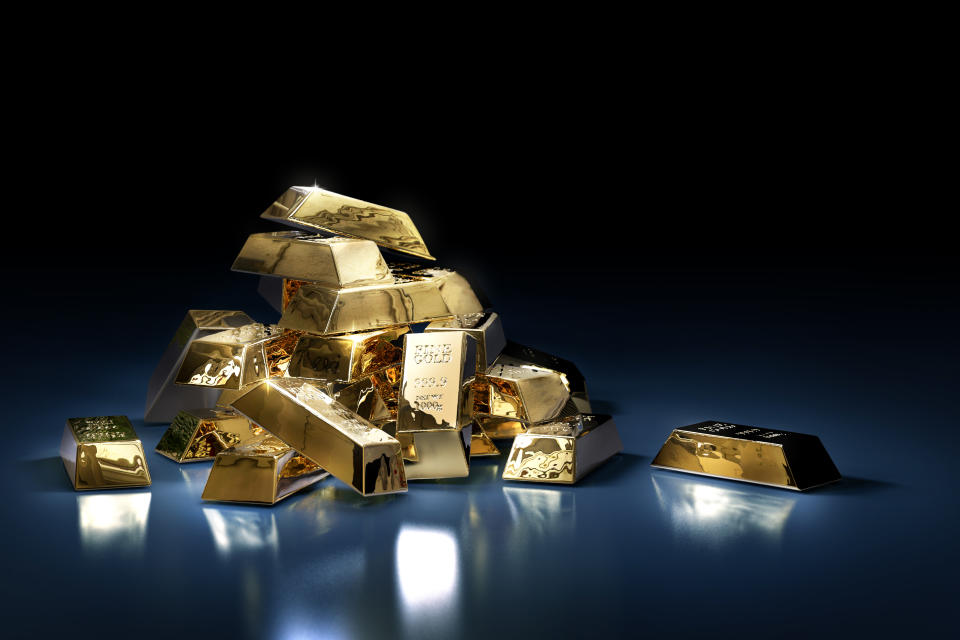 A pile of gold bars or ingots on a dark background. Photo: Getty Images