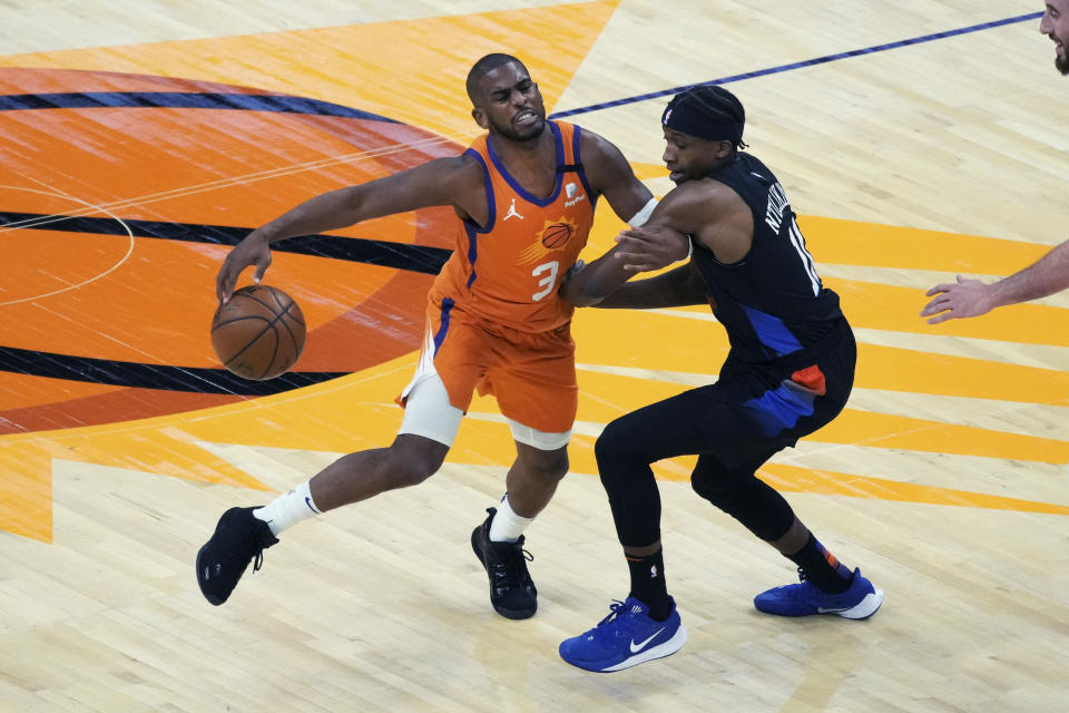 Phoenix Suns guard Chris Paul (3) is pressured by New York Knicks guard Frank Ntilikina during the first half of an NBA basketball game Friday, May 7, 2021, in Phoenix. (AP Photo/Rick Scuteri)