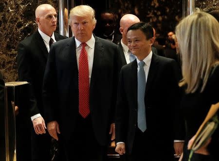 U.S. President-elect Donald Trump walks from an elevator with Alibaba Executive Chairman Jack Ma after their meeting at Trump Tower in New York, U.S., January 9, 2017. REUTERS/Mike Segar