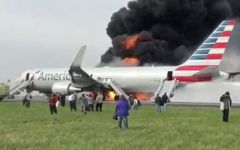 Heavy smoke can be seen coming from an American Airlines Boeing 767 after it burst into flames at Chicago’s O’Hare International Airport.