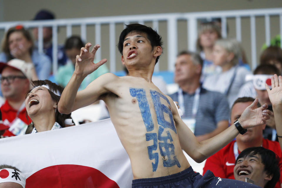 <p>A supporter of team Japan has the number sixteen, also in Japanese characters, painted on his body </p>