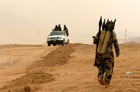 Kurdish Peshmerga fighters drive at the front line during a battle with Islamic State militants at Topzawa village near Bashiqa, near Mosul, Iraq, October 24, 2016. REUTERS/Ahmed Jadallah