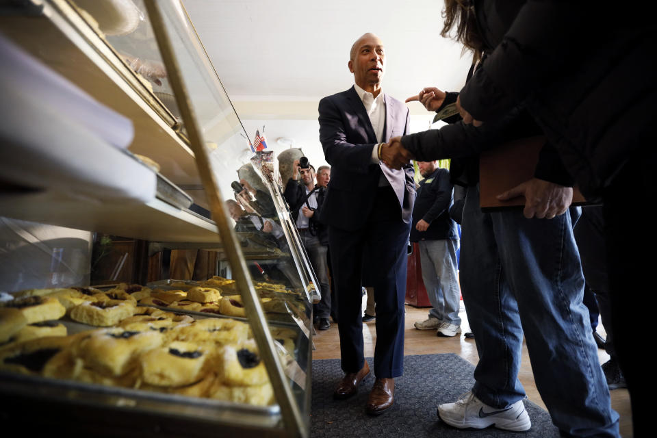 Democratic presidential candidate former Massachusetts Gov. Deval Patrick talks to local residents after placing his order at the Sykora Bakery, Monday, Nov. 18, 2019, in Cedar Rapids, Iowa. (AP Photo/Charlie Neibergall)