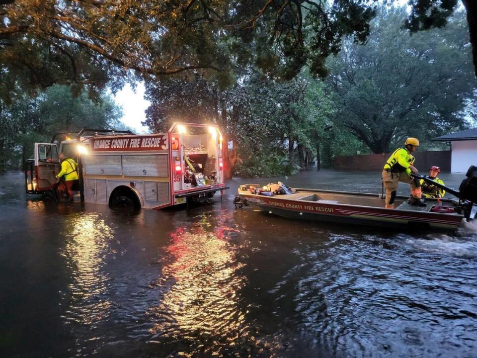 This photo provided by Orange County Fire Rescue’s Public Information Office, Orange County firefighters help people stranded by Hurricane Ian early Thursday, Sept. 29, 2022 in Orange County, Fla. Ian marched across central Florida on Thursday as a tropical storm after battering the state’s southwest coast, dropping heavy rains that caused flooding and led to inland rescues and evacuations.