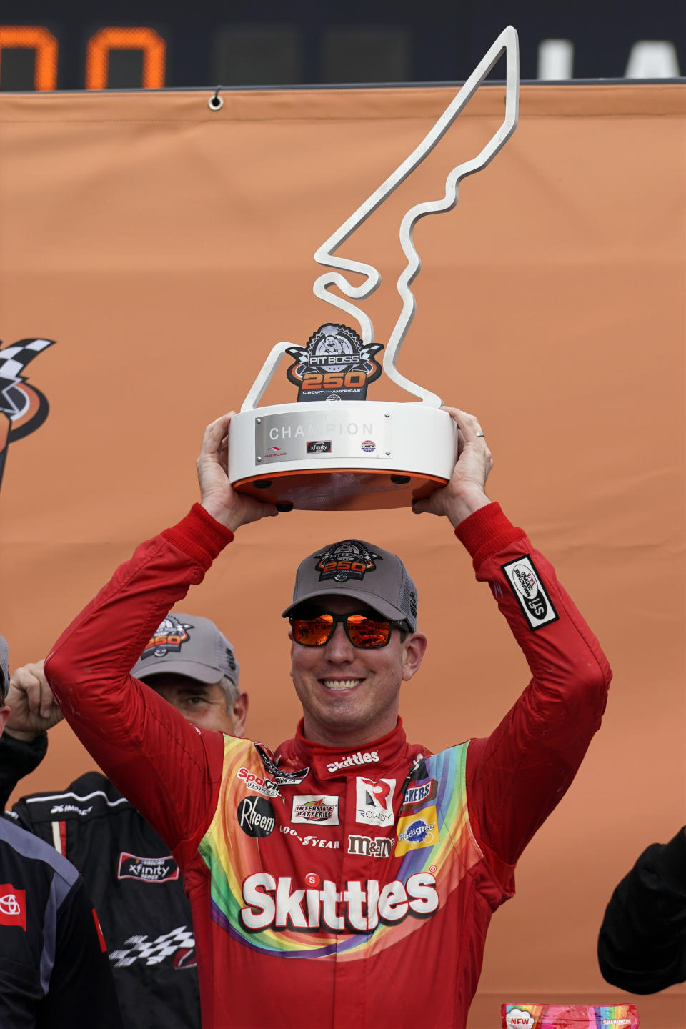 Kyle Busch raises the trophy in Victory Lane after winning the NASCAR Xfinity Series auto race at the Circuit of the Americas in Austin, Texas, Saturday, May 22, 2021. (AP Photo/Chuck Burton)