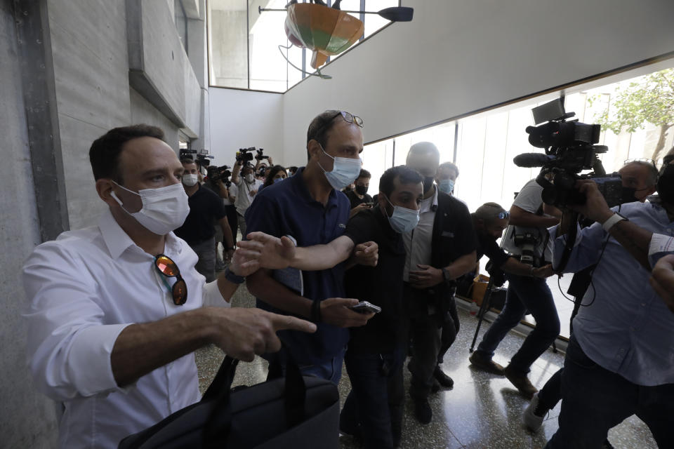 Shmulik Peleg, maternal grandfather of Eitan Biran, who survived a cable car crash in Italy that killed his immediate family, leaves court in Tel Aviv on Thursday, Sept. 23, 2021 for a hearing on charges of kidnapping his grandson. The boy's parents and younger sibling were among 14 killed in May when a cable car slammed into a mountainside in northern Italy. He is now the focus of a custody battle between his maternal grandparents in Israel and his paternal relatives in Italy. (AP Photo/Sebastian Scheiner)