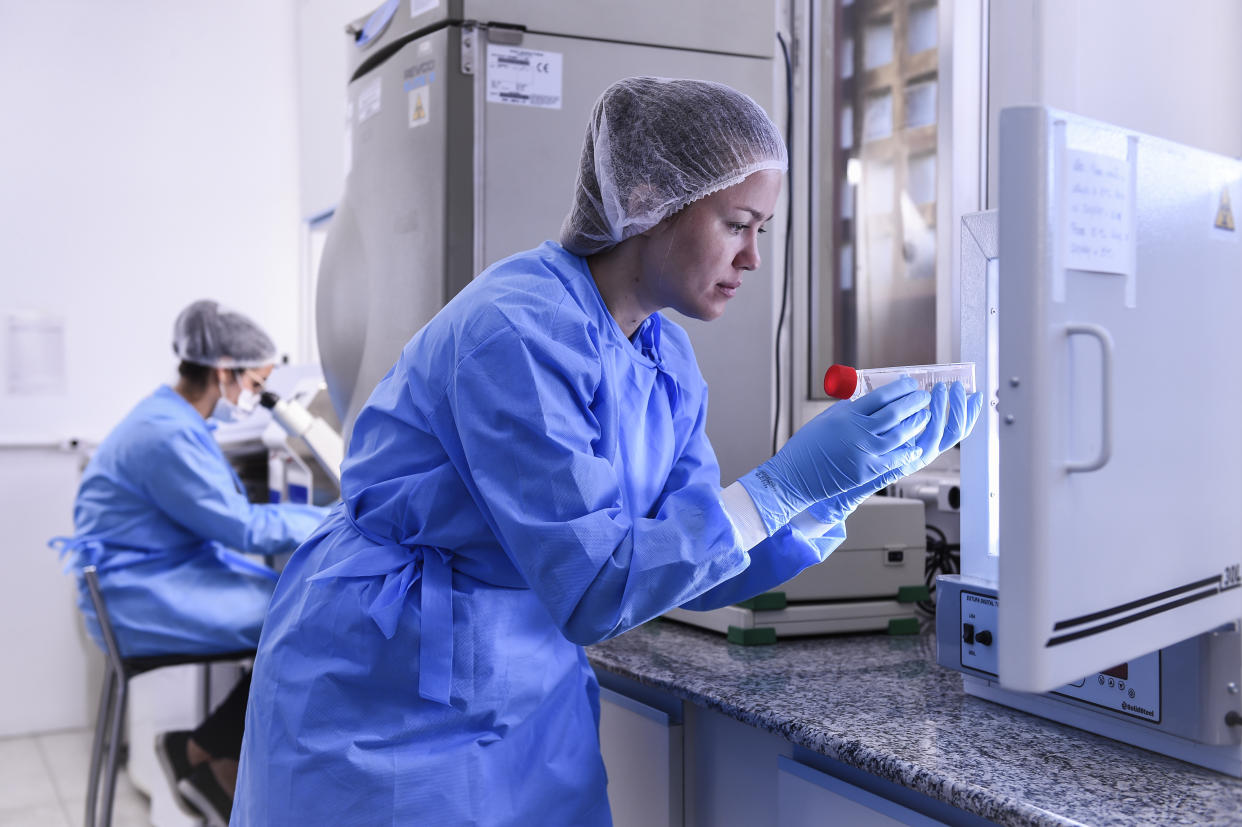 A biologist in Brazil takes a coronavirus DNA sample from the freezer.