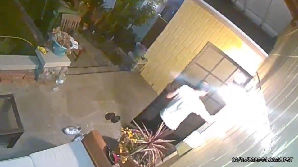 A security camera at at home next door shows Michael Herman knocking on the neighbor's door. / Credit: Superior Court of California, County of Los Angeles