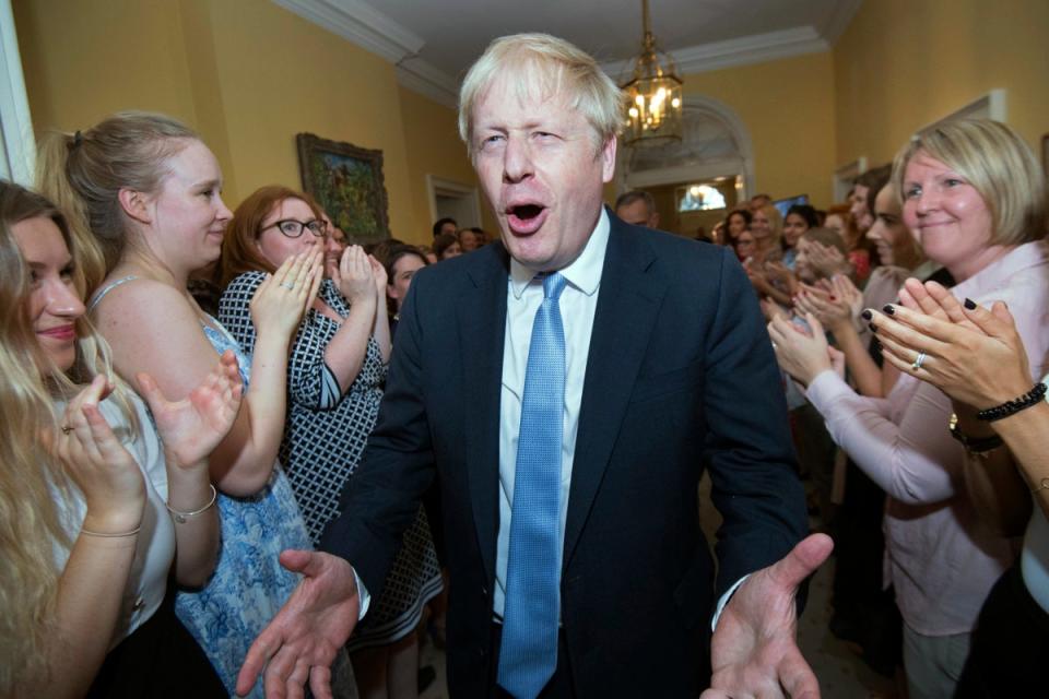 Britain's New Prime Minister Boris Johnson is welcomed into 10 Downing Street by staff (AP)