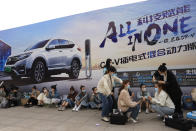 Women have their hair styled ahead of the Auto Shanghai 2021 show in Shanghai on Sunday, April 18, 2021. Automakers from around the world are showcasing their latest products this week in the world's biggest market for auto vehicles. (AP Photo/Ng Han Guan)