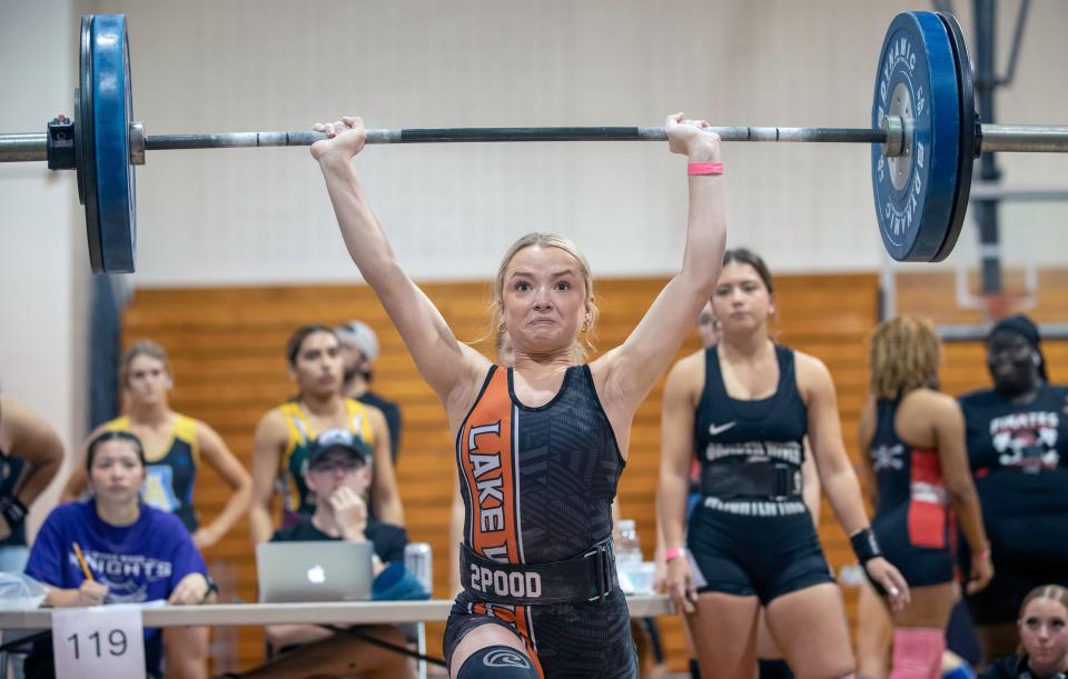 Lake Wales sophomore Jaycee Cobb completes the clean and jerk in the 119-pound weight class on Friday at the Class 2A, Region 3 girls weightlifting meet at New Port Richey High School.