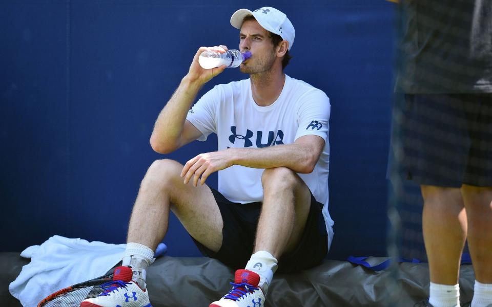 Andy Murray takes a break from Monday's training session  - AFP