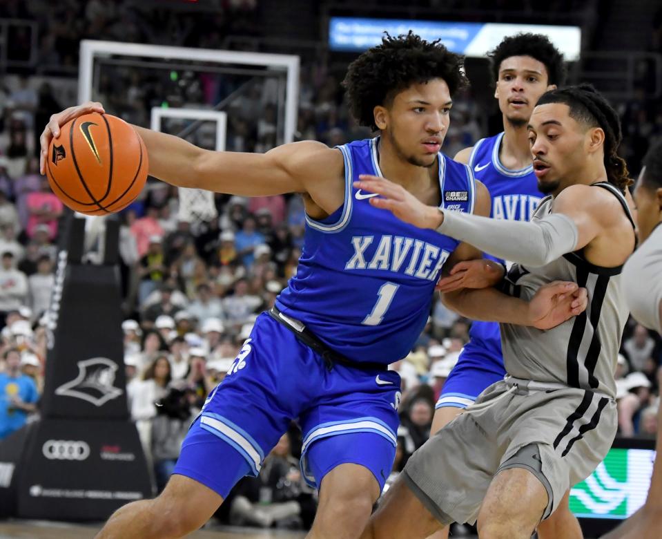 Xavier guard Desmond Claude (1) maneuvers around Providence guard Alyn Breed during the first half of an NCAA college basketball game Wednesday, March 1, 2023, in Providence, R.I.